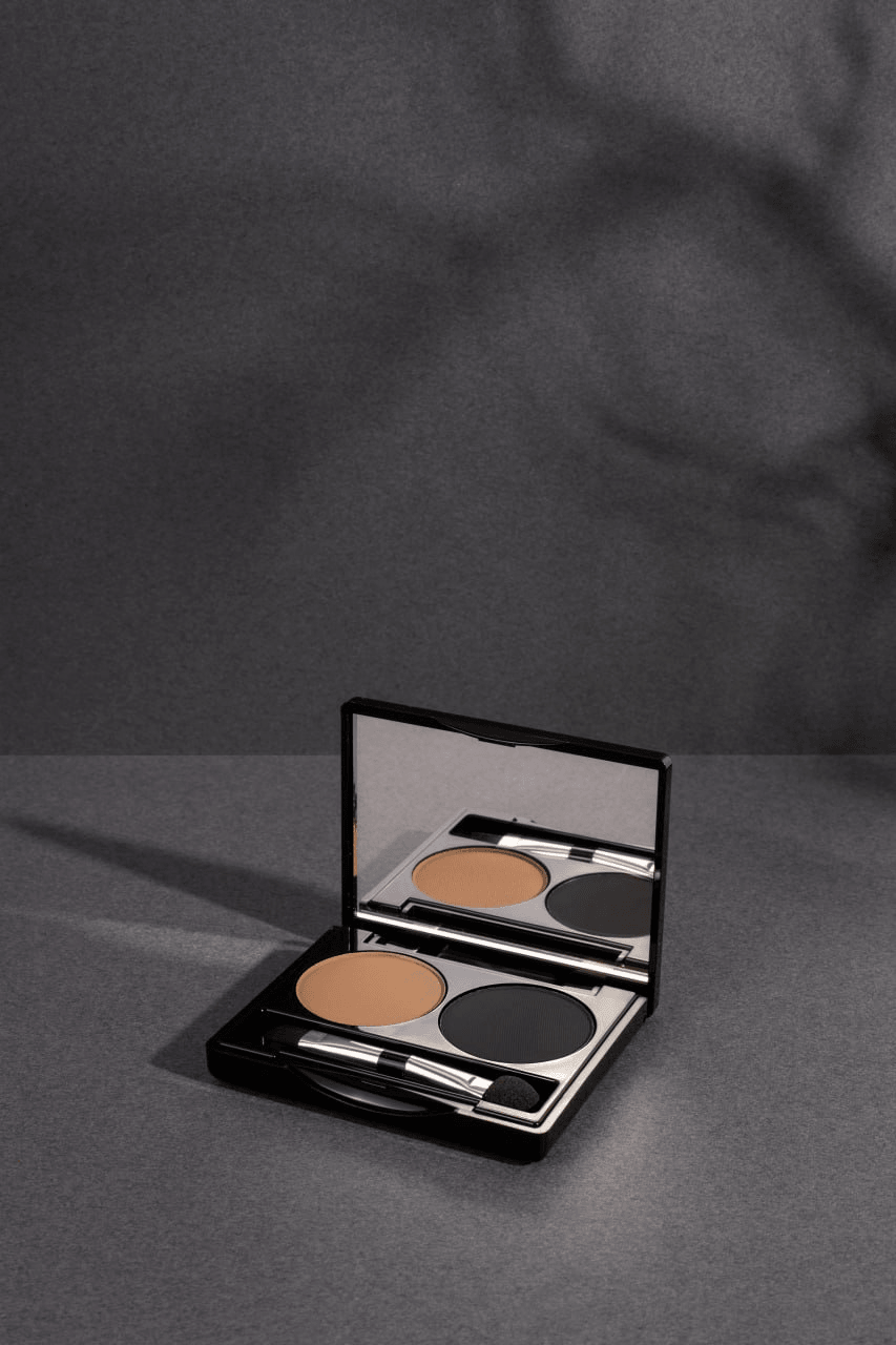 Brow Duo Palette for flawless eyebrow shaping and defining, featuring two harmonizing shades for natural or dramatic looks. Includes ingredients like Talc, Mica, and Ethylhexyl Palmitate, and usage tips for perfect brows. Made in Canada, net weight 5g/0.18 us oz.